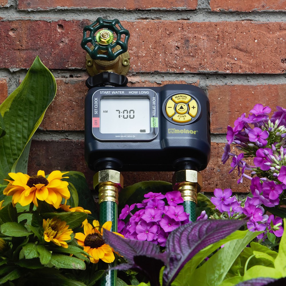 Melnor 65139AMZ AquaTimer two-zone digital water timer installed on a faucet